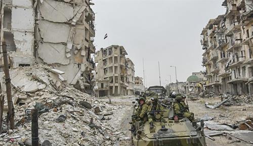 Russian soldiers travel through ruins of Aleppo, Syria