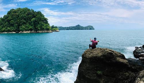 Photograph of two people on a pristine rocky shore in Costa Rica.